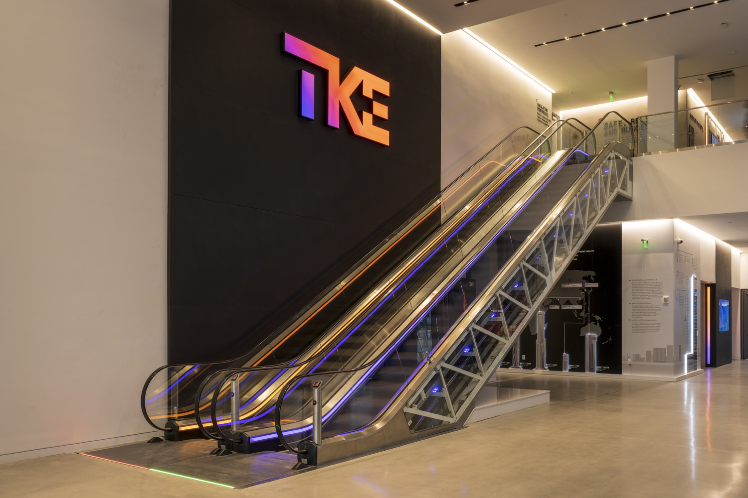 The IQC lobby with a glass escalator and exposed testing machinery