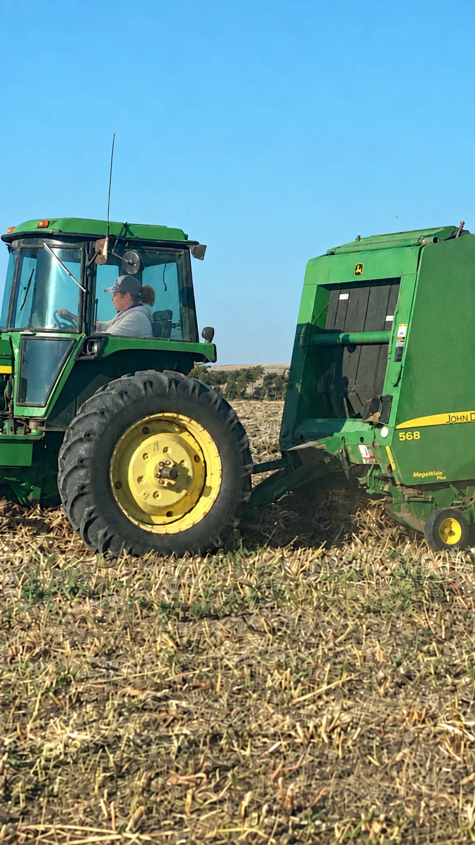 Tractor and baler working a field